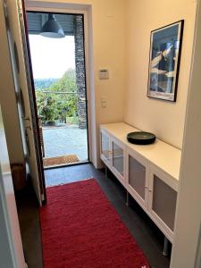a room with a counter and a red rug at Traumhaus mit herrlichem Blick über Graz in Sankt Veit am Vogau