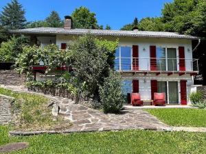 a house with red chairs in front of it at Traumhaus mit herrlichem Blick über Graz in Sankt Veit am Vogau