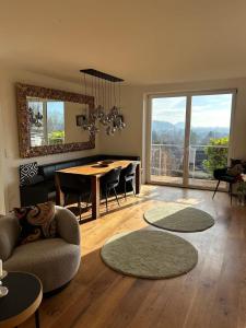 a living room with a table and a dining room at Traumhaus mit herrlichem Blick über Graz in Sankt Veit am Vogau +29 photos