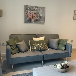 a living room with a blue couch with pillows at Spacious City Centre 2 Bedroom Apartment in Liverpool