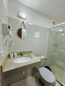 a bathroom with a sink and a toilet and a shower at Búzios Apartamento Charmoso in Búzios +13 photos
