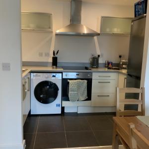 a kitchen with a dishwasher and a washer at Spacious City Centre 2 Bedroom Apartment in Liverpool