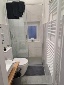 a bathroom with a shower and a toilet and a sink at The way to trieste bikes storage in Trieste +21 photos