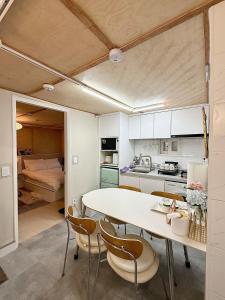 a kitchen with a table and chairs and a bed at Forest SB02 in Seoul