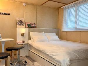 a bedroom with a bed with a window and a desk at Forest SB02 in Seoul