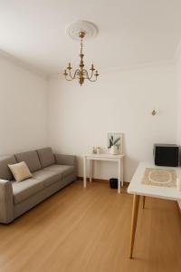 a living room with a couch and a table at Wood Green Central Cozy Rooms in London