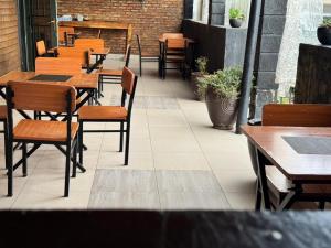 a row of tables and chairs in a restaurant at Vilimani Garden Residence in Rwamagana