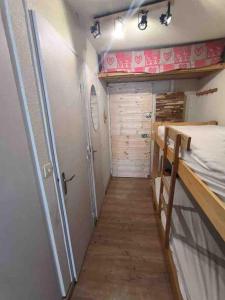 a small room with a bed and a closet at Très beau studio pieds des pistes tout rénové in Risoul +22 photos