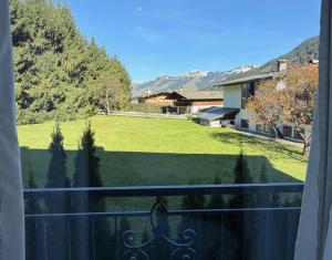 a view of a yard from a balcony at KITZHORN EMOTIONS near skilift by Belle-Stay in Jochberg