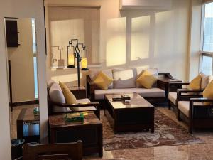 a living room with a couch and a table at Arto Aparthotel in Riyadh