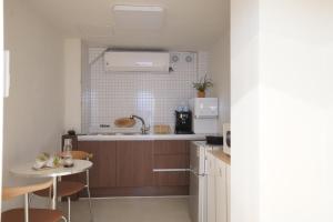 a kitchen with a sink and a table at stay105행궁 in Suwon