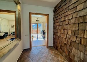 a hallway with a brick wall and a mirror at KITZHORN EMOTIONS near skilift by Belle-Stay in Jochberg +37 photos