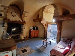 an overhead view of a living room with a fireplace at Le Clou de Malte in Vézins-de-Lévézou