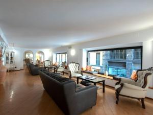 a large living room with couches and a fireplace at B&B Hotel Firenze Pitti Palace al Ponte Vecchio in Florence +28 photos