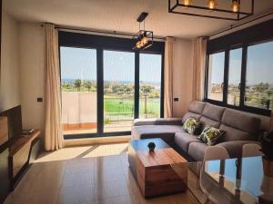 a living room with a couch and a large window at Large terrace and views in Retamar