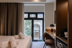 a hotel room with a bed and a window at Moontels Colón in Valencia