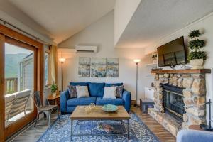 a living room with a blue couch and a fireplace at Top Of Seven in Seven Devils