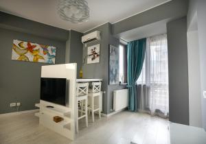 a living room with a flat screen tv on a wall at Homey Apartment Obor in Bucharest