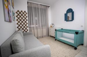 a living room with a couch and a dresser at Homey Apartment Obor in Bucharest