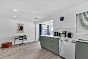 an empty kitchen with a desk and a chair at Cozy Hollywood Private Pool Retreat - Ping pong in Hollywood