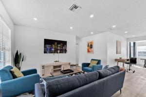 a living room with two blue chairs and a couch at Cozy Hollywood Private Pool Retreat - Ping pong in Hollywood