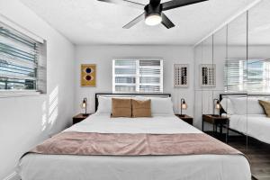 a bedroom with a bed and a ceiling fan at Cozy Hollywood Private Pool Retreat - Ping pong in Hollywood +31 photos