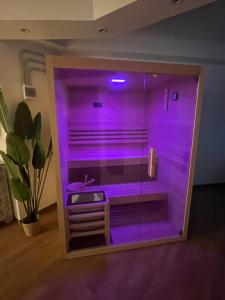 a purple shower in a room with a sink at Olbia City Hotel & Spa in Olbia
