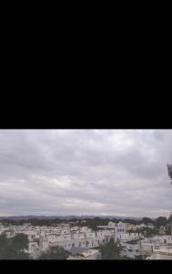 a view of a city with white buildings at Gurukrupa Home stay in Rājpīpla
