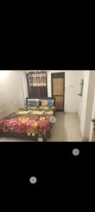 a bedroom with two beds in a room at Gurukrupa Home stay in Rājpīpla