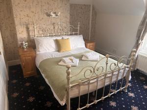 a bedroom with a bed with two towels on it at The Beaumont in Sittingbourne
