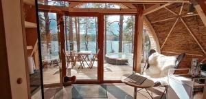 a living room with a couch and a table with a laptop at Nameliai Miškuose in Molėtai