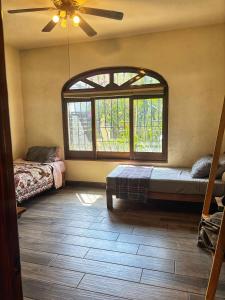 a room with two beds and a large window at Casita El Nido- Spacious 2 Bedroom Main Floor Apartment in Bucerías