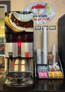 a coffee machine with a plate of food on a counter at Super 8 by Wyndham Hillsville in Hillsville
