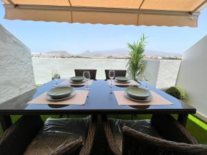 a dining table with a view of the water at Precioso Atico Vista Teide in Las Galletas