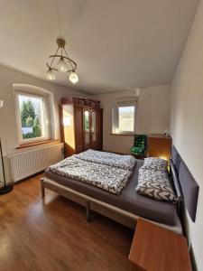 a bedroom with a large bed in a room at Wiejsko-Sielsko in Szczytna