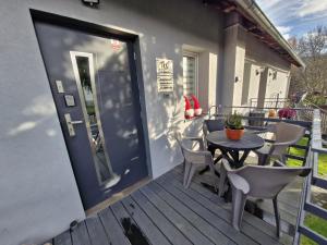 a patio with a table and chairs on a deck at Wiejsko-Sielsko in Szczytna