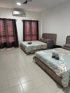 Ένα ή περισσότερα κρεβάτια σε δωμάτιο στο PakyaZ Homestay