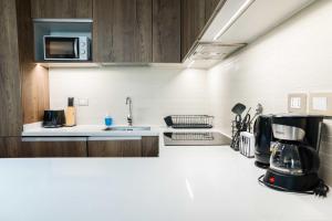a kitchen with a coffee maker on a counter at Luxury and Comfort in the Heart of Las Condes in Santiago