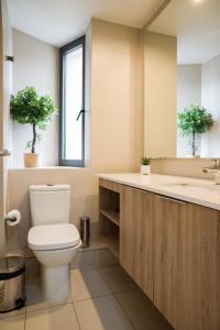 a bathroom with a toilet and a sink at Luxury and Comfort in the Heart of Las Condes in Santiago +48 photos