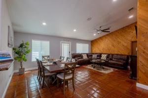a living room with a table and a couch at Family Oasis at Sunrise Private Pool, Game, Cardio, Grill, Work & Play in Sunrise