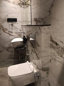 a bathroom with a white toilet and a sink at Silvotel Premier By Bizzgrow Hotels in Indore +17 photos