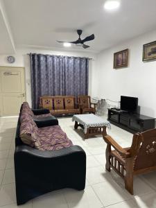 a living room with a couch and a table at PakyaZ Homestay in Kuching