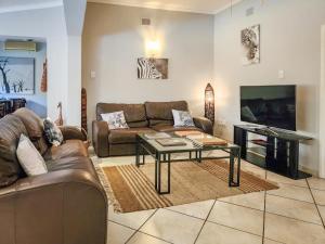a living room with a couch and a coffee table at Parkers Cottages in St Lucia
