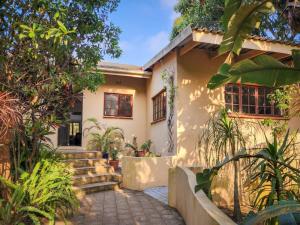 a house with a pathway in front of it at Parkers Cottages in St Lucia