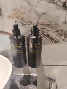 two bottles ofodorizers sitting on a counter in a bathroom at Silvotel Premier By Bizzgrow Hotels in Indore