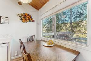 a dining room with a table and a large window at The Treehouse in Lake Arrowhead +18 photos