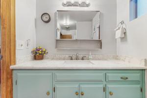 a bathroom with a sink and a mirror at The Treehouse in Lake Arrowhead