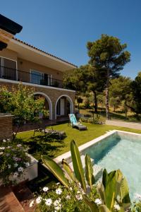 a house with a swimming pool in the yard at Villa Calma by A&D Properties in Porto Rafti