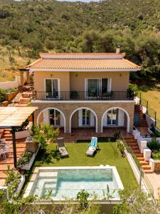 an image of a house with a swimming pool at Villa Calma by A&D Properties in Porto Rafti