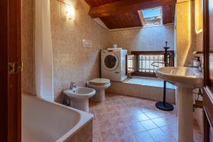 a bathroom with a toilet and a sink and a washing machine at Elegant Attic-Rovigo Center-6 people in Rovigo +23 photos